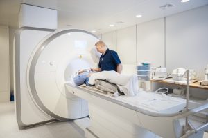 MRI Technologist overlooking patient